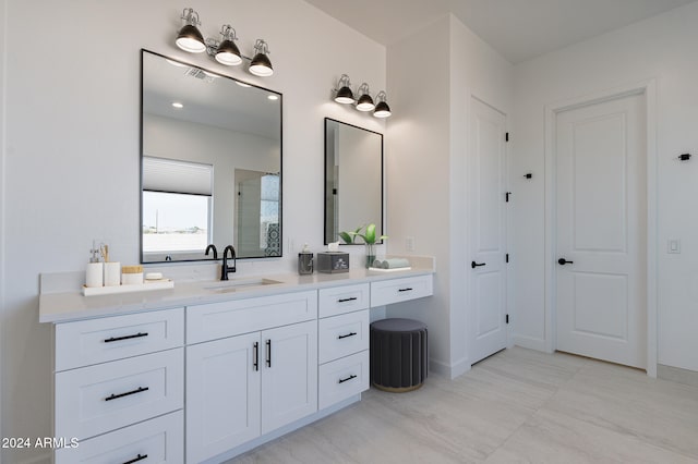 bathroom featuring vanity and a shower with door