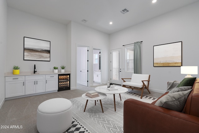 carpeted living room with wet bar and wine cooler