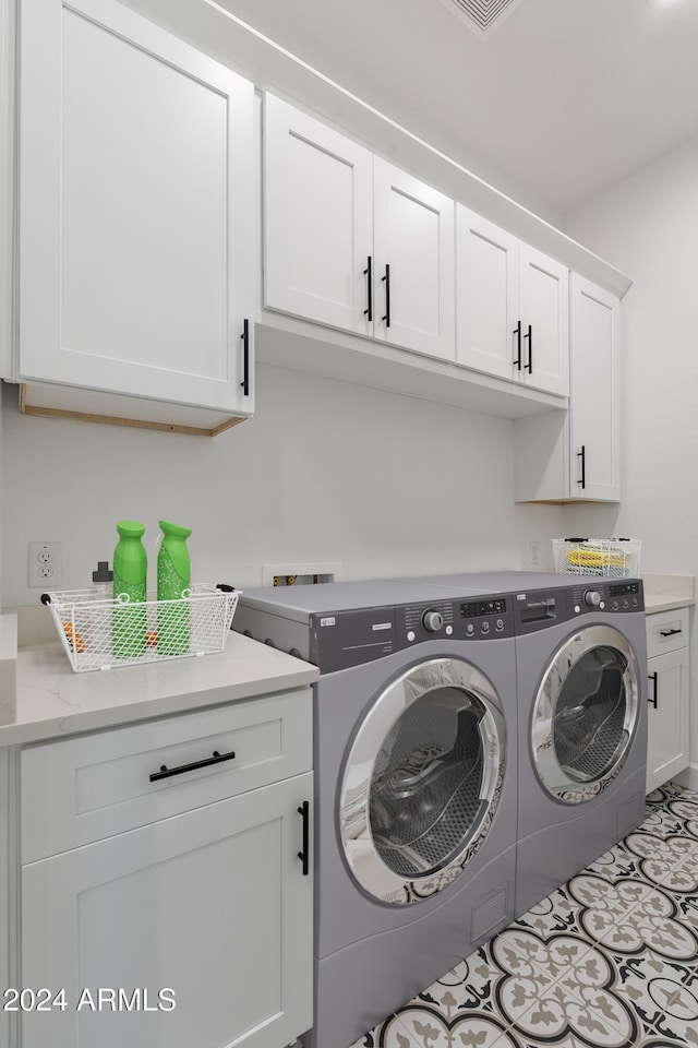 washroom with cabinets and independent washer and dryer