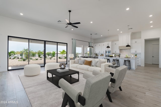 living room featuring ceiling fan and light hardwood / wood-style flooring