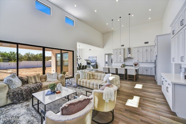 living room with hardwood / wood-style floors and a high ceiling