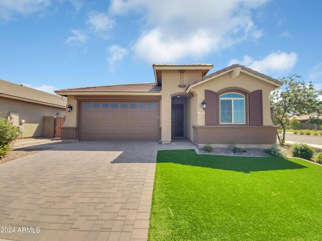 view of front facade with a garage and a front lawn