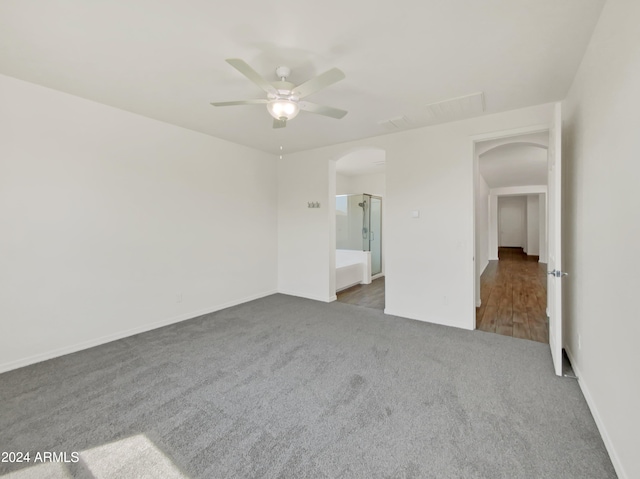 spare room with dark wood-type flooring and ceiling fan