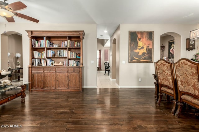 living area featuring recessed lighting, a ceiling fan, hardwood / wood-style floors, and arched walkways
