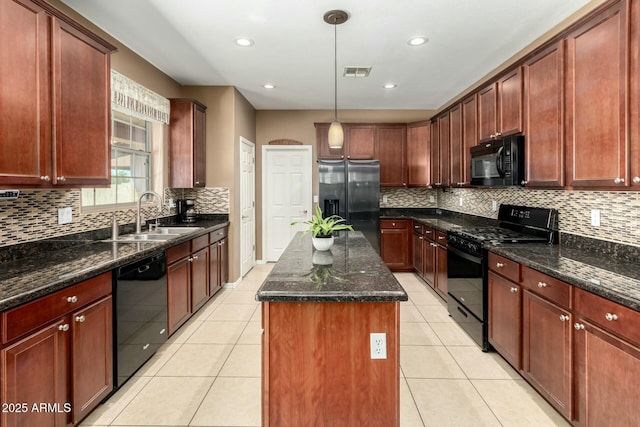 kitchen with decorative backsplash, a sink, visible vents, a center island, and black appliances