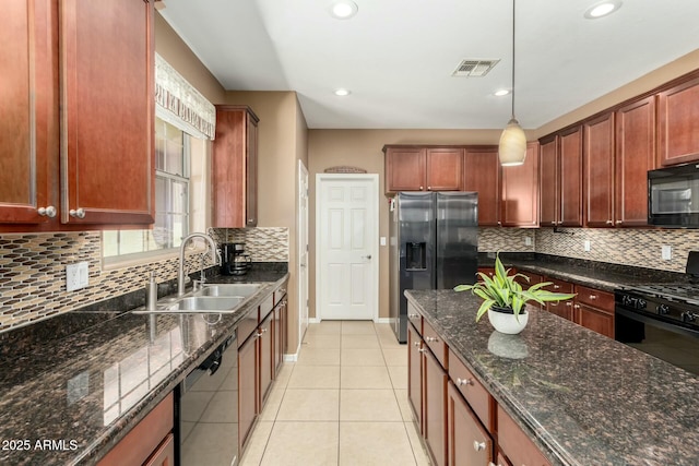 kitchen featuring light tile patterned floors, decorative backsplash, a sink, visible vents, and black appliances