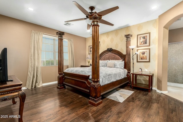 bedroom featuring baseboards, visible vents, and wood finished floors