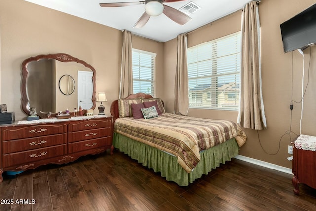bedroom featuring dark wood-style floors, visible vents, ceiling fan, and baseboards
