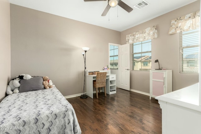 bedroom with a ceiling fan, visible vents, baseboards, and dark wood-type flooring