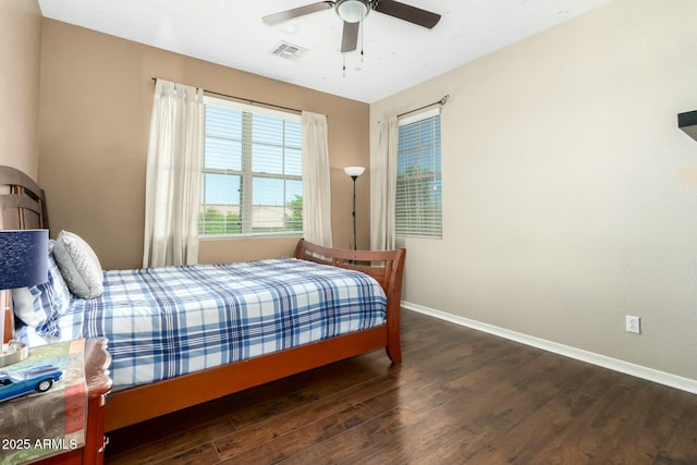 bedroom featuring wood finished floors, visible vents, ceiling fan, and baseboards