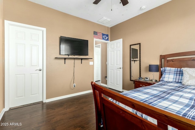 bedroom with dark wood-style flooring, a ceiling fan, and baseboards