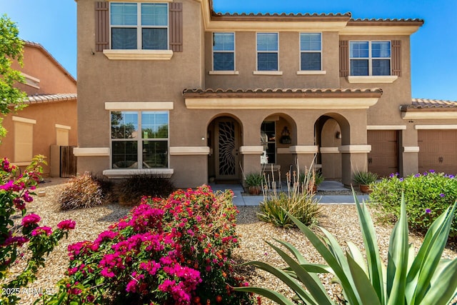 view of front of property featuring stucco siding and a tiled roof