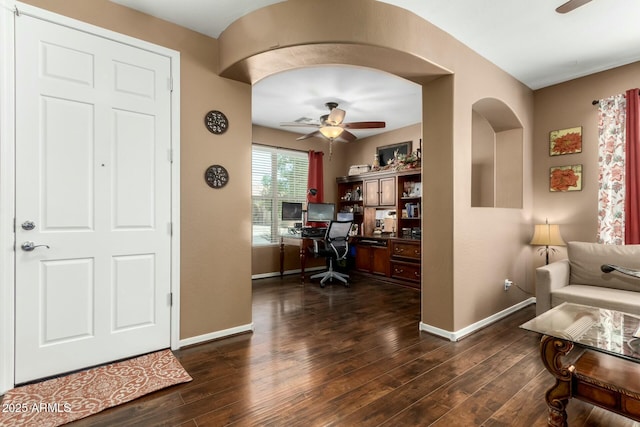 office with baseboards, ceiling fan, and dark wood-type flooring