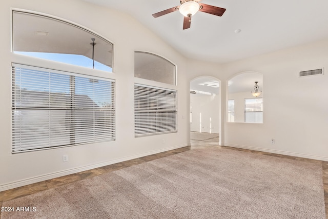 spare room featuring ceiling fan, plenty of natural light, and vaulted ceiling