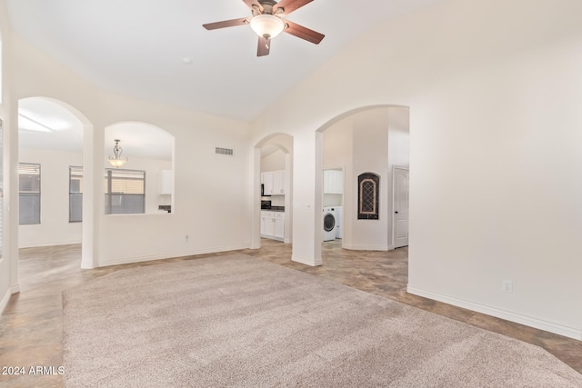 unfurnished living room with washer / clothes dryer, high vaulted ceiling, and ceiling fan