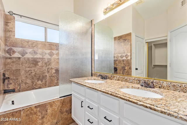 bathroom with vanity and tiled shower / bath