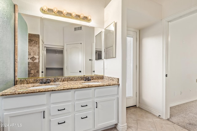 bathroom with tile patterned floors and vanity