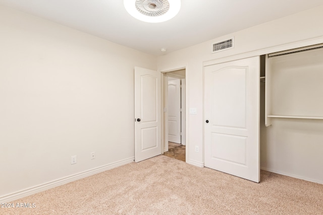 unfurnished bedroom with light colored carpet