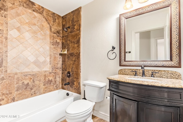 full bathroom with vanity, tiled shower / bath combo, and toilet