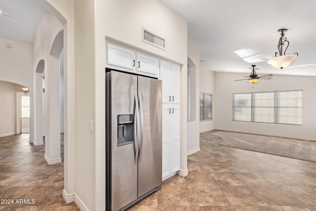 kitchen featuring white cabinetry, ceiling fan, stainless steel refrigerator with ice dispenser, pendant lighting, and vaulted ceiling