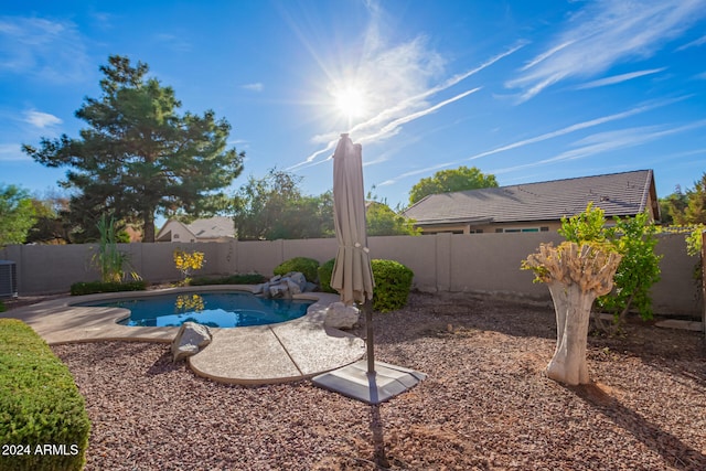 view of swimming pool featuring central AC unit