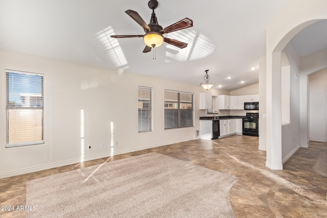 unfurnished living room with ceiling fan and lofted ceiling