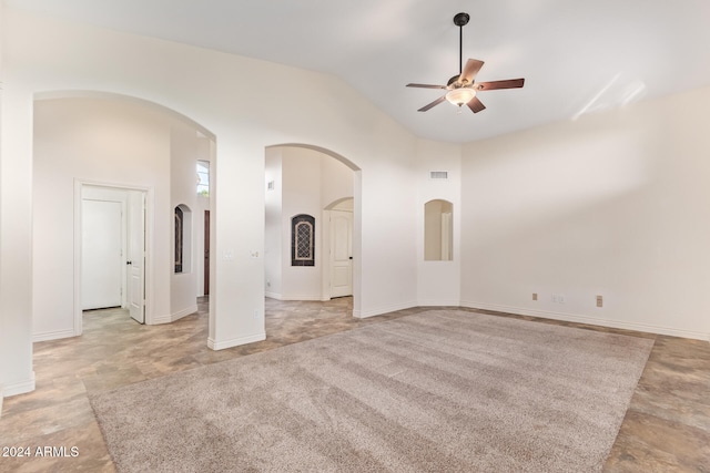 spare room with ceiling fan and high vaulted ceiling