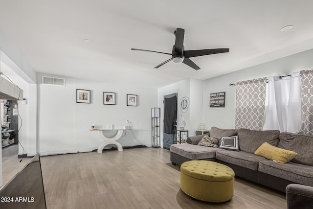 living room with light hardwood / wood-style floors and ceiling fan