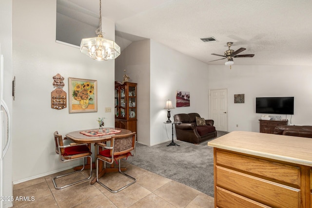 6424 E Aire Libre Ln, Scottsdale, AZ 85254 - dining room featuring vaulted ceiling, ceiling fan, light tile patterned floors, a chandelier, and light carpet
