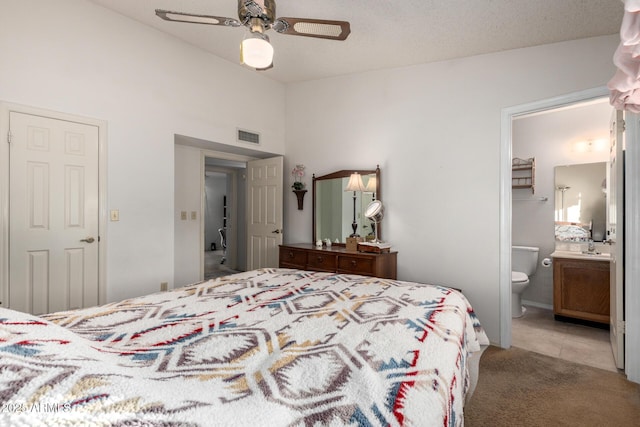 6424 E Aire Libre Ln, Scottsdale, AZ 85254 - bedroom featuring connected bathroom, light colored carpet, lofted ceiling, ceiling fan, and light tile patterned floors