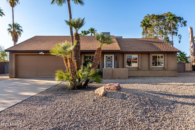 6424 E Aire Libre Ln, Scottsdale, AZ 85254 - single story home featuring a garage, concrete driveway, stucco siding, and a shingled roof