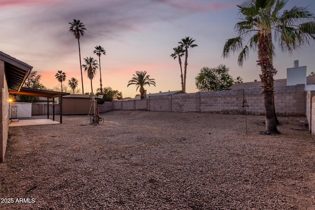 6424 E Aire Libre Ln, Scottsdale, AZ 85254 - yard at dusk with a fenced backyard and a patio
