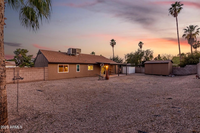 6424 E Aire Libre Ln, Scottsdale, AZ 85254 - back of house featuring central air condition unit, a fenced backyard, a patio area, driveway, and a garage