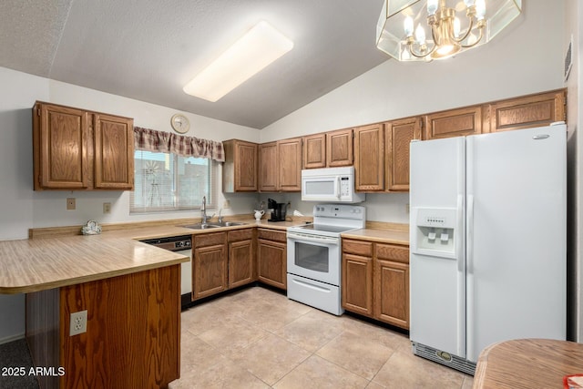 6424 E Aire Libre Ln, Scottsdale, AZ 85254 - kitchen with white appliances, a sink, vaulted ceiling, brown cabinets, and a peninsula
