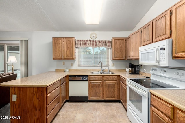 6424 E Aire Libre Ln, Scottsdale, AZ 85254 - kitchen with a sink, white appliances, a peninsula, light countertops, and lofted ceiling