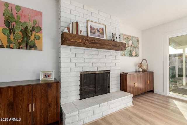 living area with wood finished floors and a fireplace