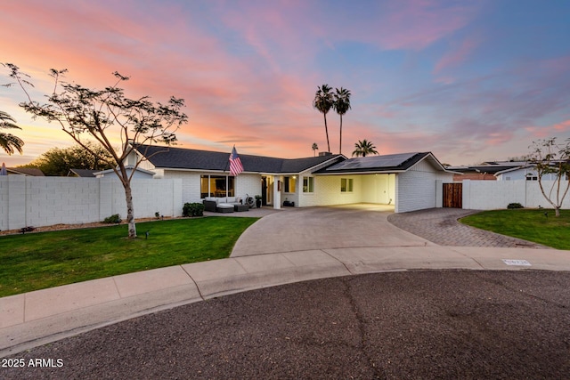 ranch-style home featuring driveway, a front lawn, and fence