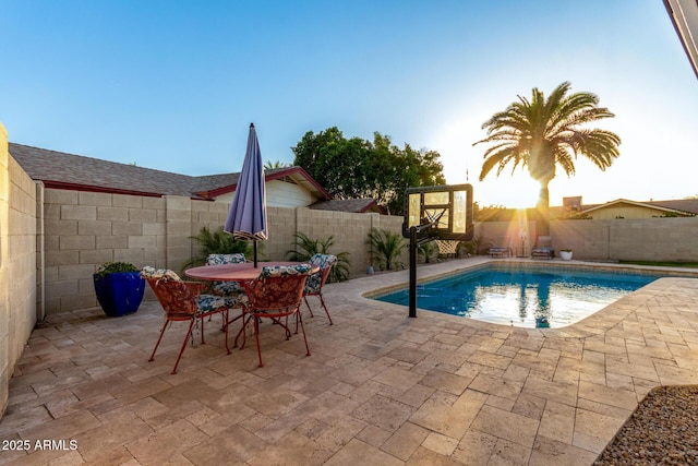 view of pool featuring outdoor dining area, a fenced backyard, and a patio area