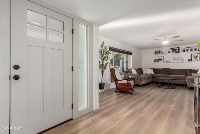 foyer with a ceiling fan and light wood-style floors