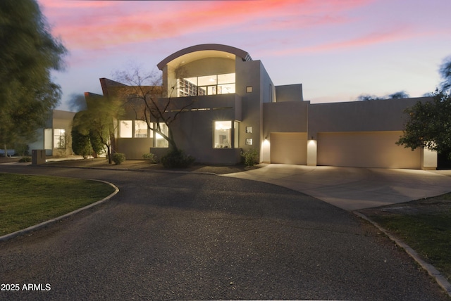 view of front of home with a balcony and a garage