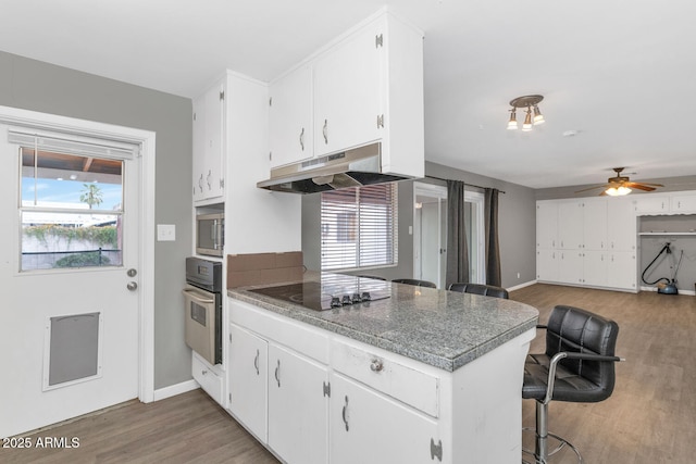 kitchen featuring plenty of natural light, stainless steel appliances, and white cabinets