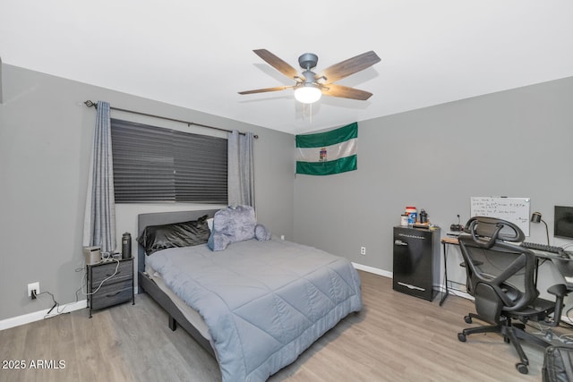 bedroom with light hardwood / wood-style floors and ceiling fan