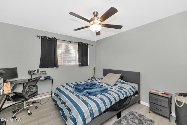 bedroom with ceiling fan and light hardwood / wood-style floors