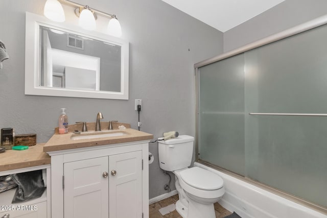 full bathroom featuring vanity, toilet, and combined bath / shower with glass door