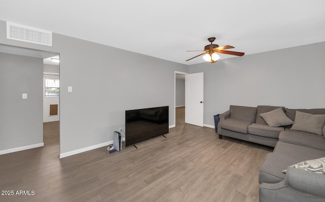 living room featuring hardwood / wood-style floors and ceiling fan