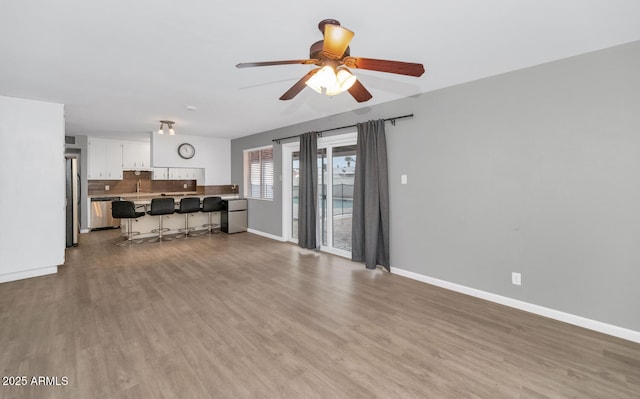 living room with ceiling fan and light hardwood / wood-style flooring