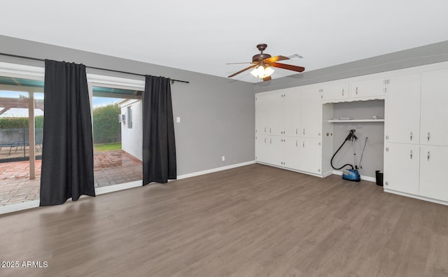 interior space with dark wood-type flooring and ceiling fan