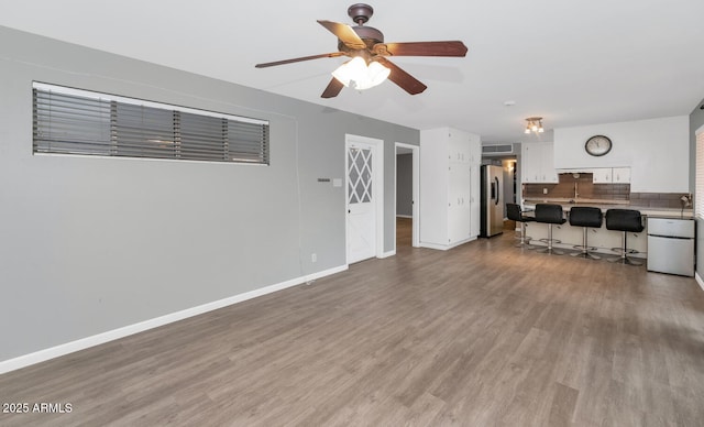 living room with hardwood / wood-style floors and ceiling fan