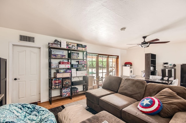 living room with visible vents, french doors, wood finished floors, and a textured ceiling