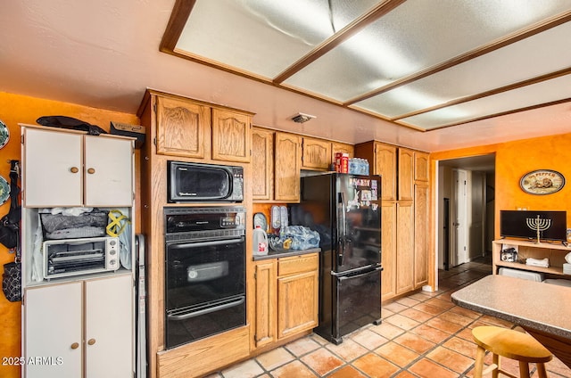 kitchen with dark countertops, a toaster, black appliances, brown cabinets, and a warming drawer